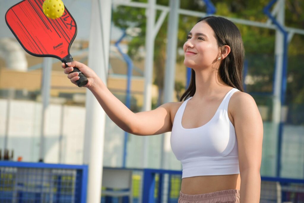 A person enjoying a casual game of pickleball outdoors, symbolising how staying updated with trends like SEO vs. SGE can feel like keeping up with evolving sports and technologies.
